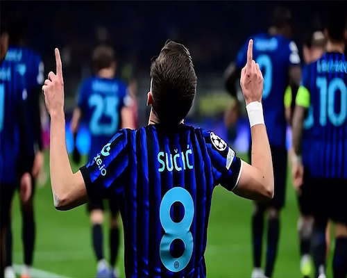 Petar Sučić celebra de rodillas y de espaldas señalando al cielo tras su gol para Internazionale, con sus compañeros al fondo.