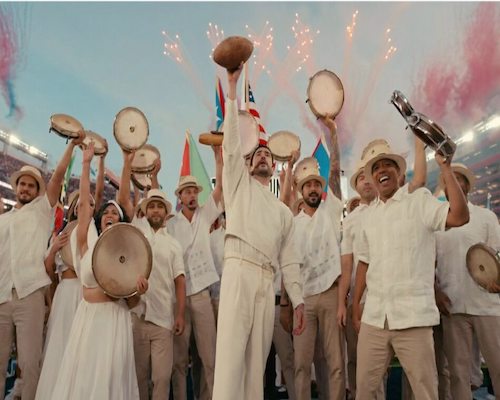 Bad Bunny de pie sobre una camioneta durante su show de mediotiempo en el Super Bowl 2026, rodeado de bailarines y una escenografía natural.