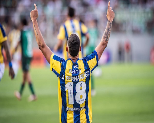 Jugador de Rosario Central, Fernández número 18, celebra con los brazos en alto durante un partido de Copa Argentina